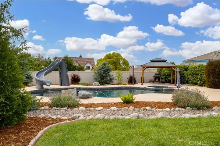 The Sparkling PebbleTec Pool and Spa with UV Sterilization System, Water Slide, Baja Reef and Jump Rock Were Added in 2021 and are Located in a Separately-Gated, Landscaped Yard with a Lighted Gazebo and Fireplace to Enjoy It Day or Night (Fire added virtually)