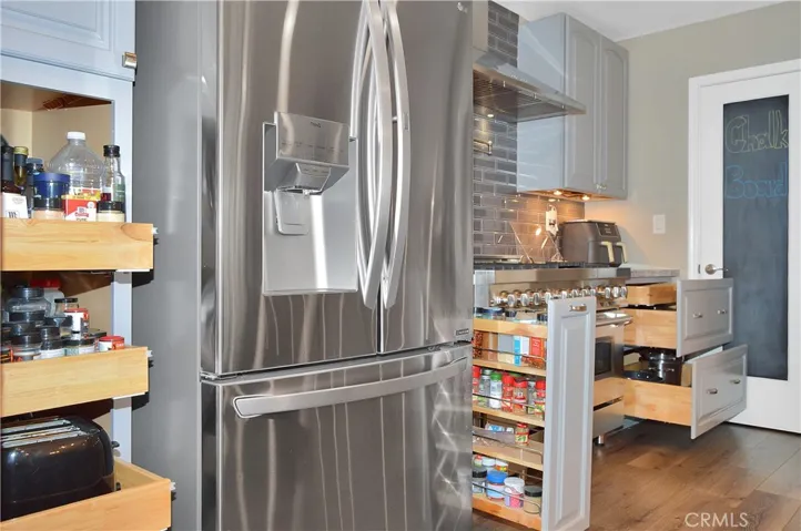 Check out the cabinet upgrades! Pull-out shelves, spice rack next to the range, and pot and pan drawers with lid storage next to the walk-in pantry.