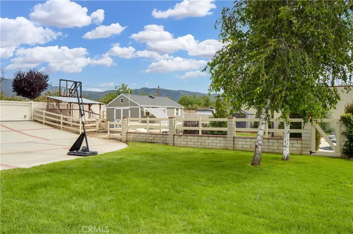 What an amazing place to call home! Abundant lawn space, gated pool area, country-style fun with your very own chickens (yes, they are included if you want them), and views of the local mountains in the distance.