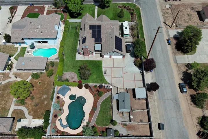 This fabulous half-acre lot offers abundant fenced and cross-fenced backyard space with an automatic gate leading to the 3-car garage, RV parking with hook-ups, plenty of extra driveway parking, an inviting lawn to play on, the sparkling pool and spa area, and a bit of country living with a chicken coop and dog run which both have access to a heated shed to keep them warm and safe. Plus, there's a second drive-through gate to the yard in the back - perfect for projects or extra storage.