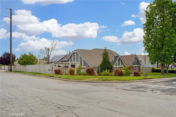 Corner view showing the vinyl fencing encompassing the spacious backyard and driveway space