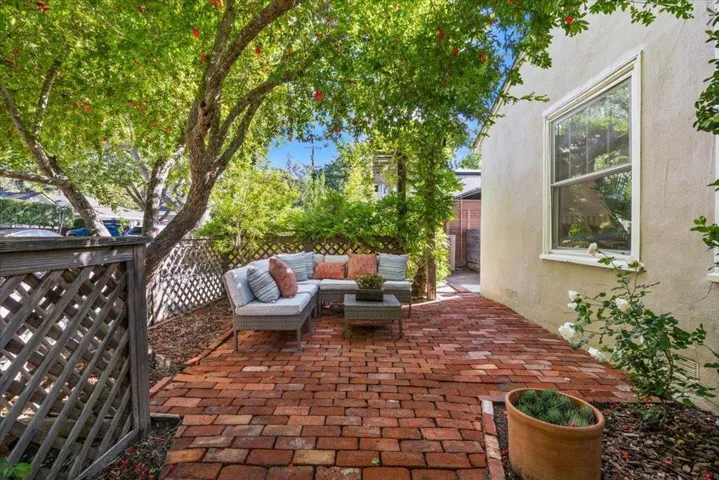 Red brick front patio 'neath the flowering pomegranate tree.