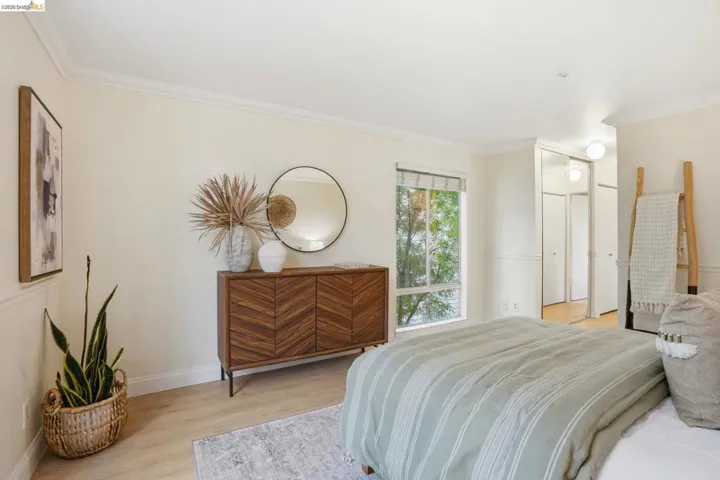 Neutral wall color, crown molding, and wood-finish flooring