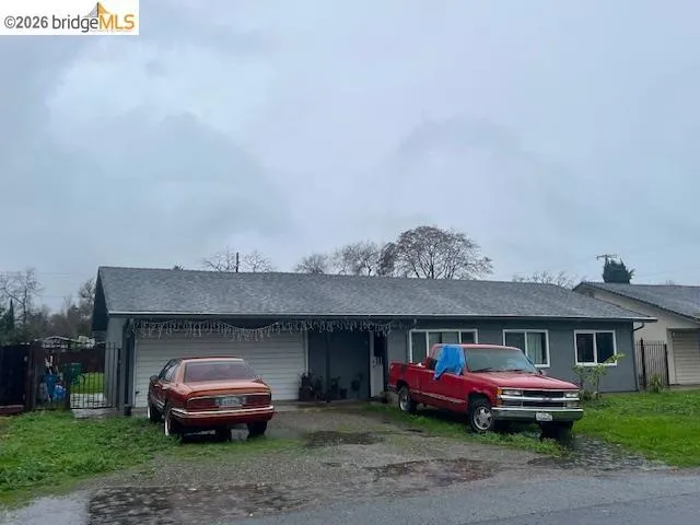 Single story home with driveway, a shingled roof, and a garage