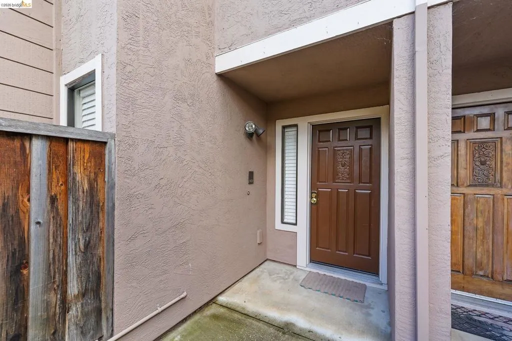View of exterior entry with stucco siding