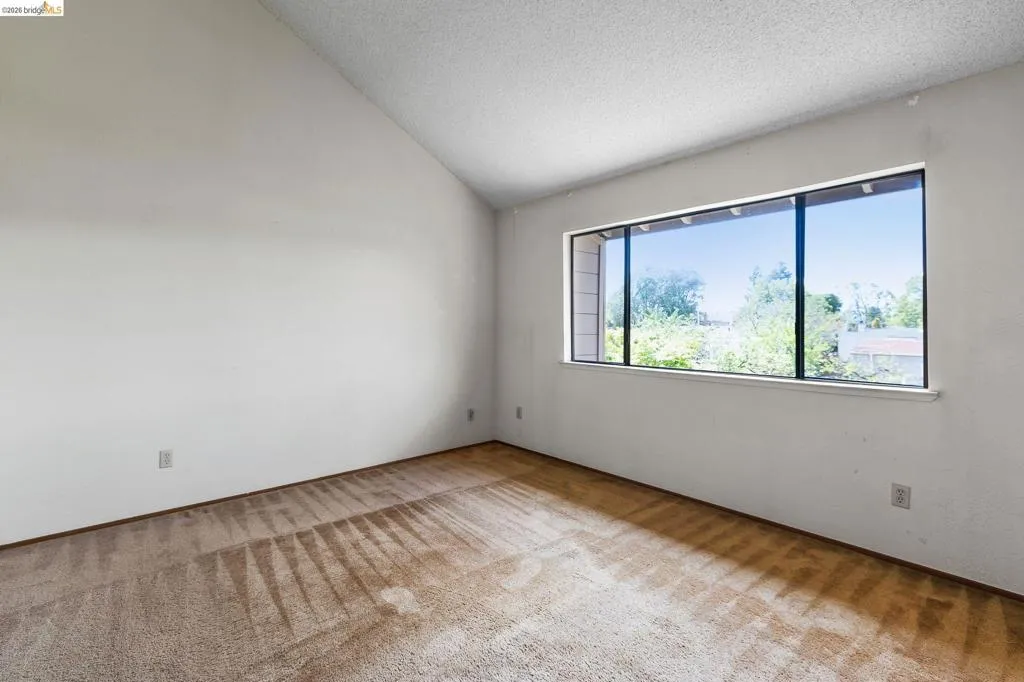 Unfurnished room featuring light colored carpet