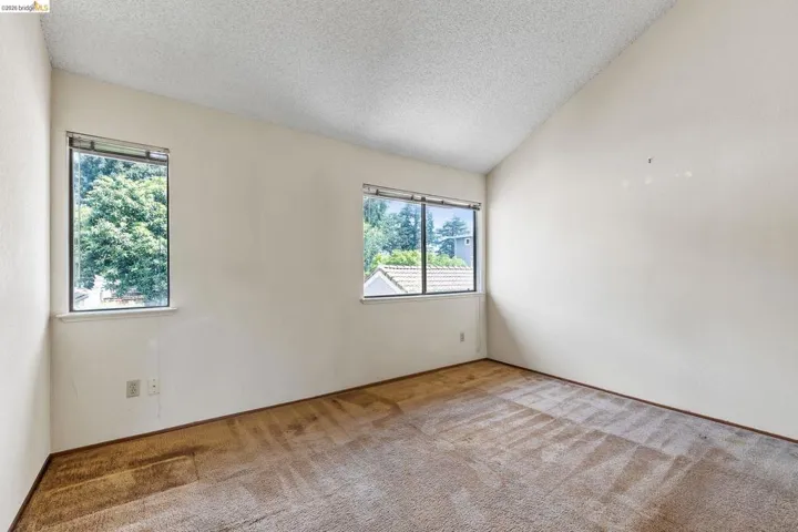Carpeted empty room with healthy amount of natural light