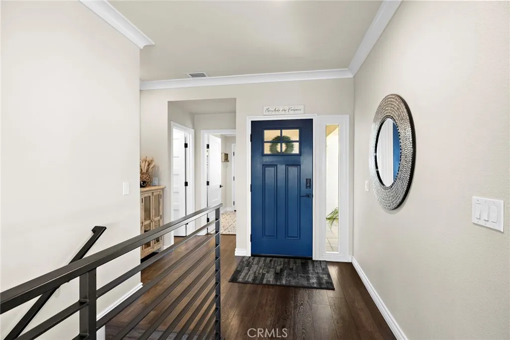 Looking back towards the 1/2 bath for guests, the large laundry room and direct access to the garage