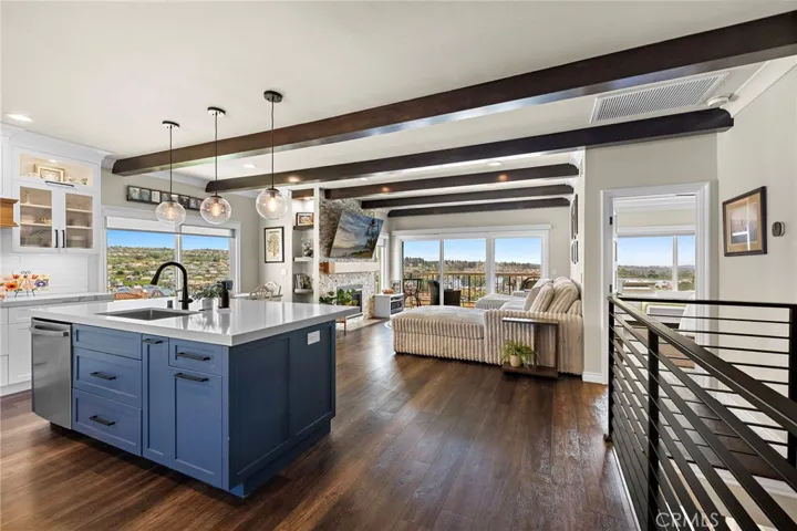 This 'GREAT ROOM' is Gorgeous!!!!  Custom fireplace, fully custom kitchen, lots of storage and GREAT views.  THE LAKE IS RIGHT THERE... AND SO SOOTHING AND BEAUTIFUL! Notice the door on the right - How awesome to have the master bedroom on this floor!