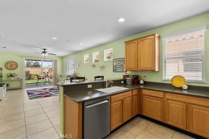 Kitchen opens to family room with backyard views