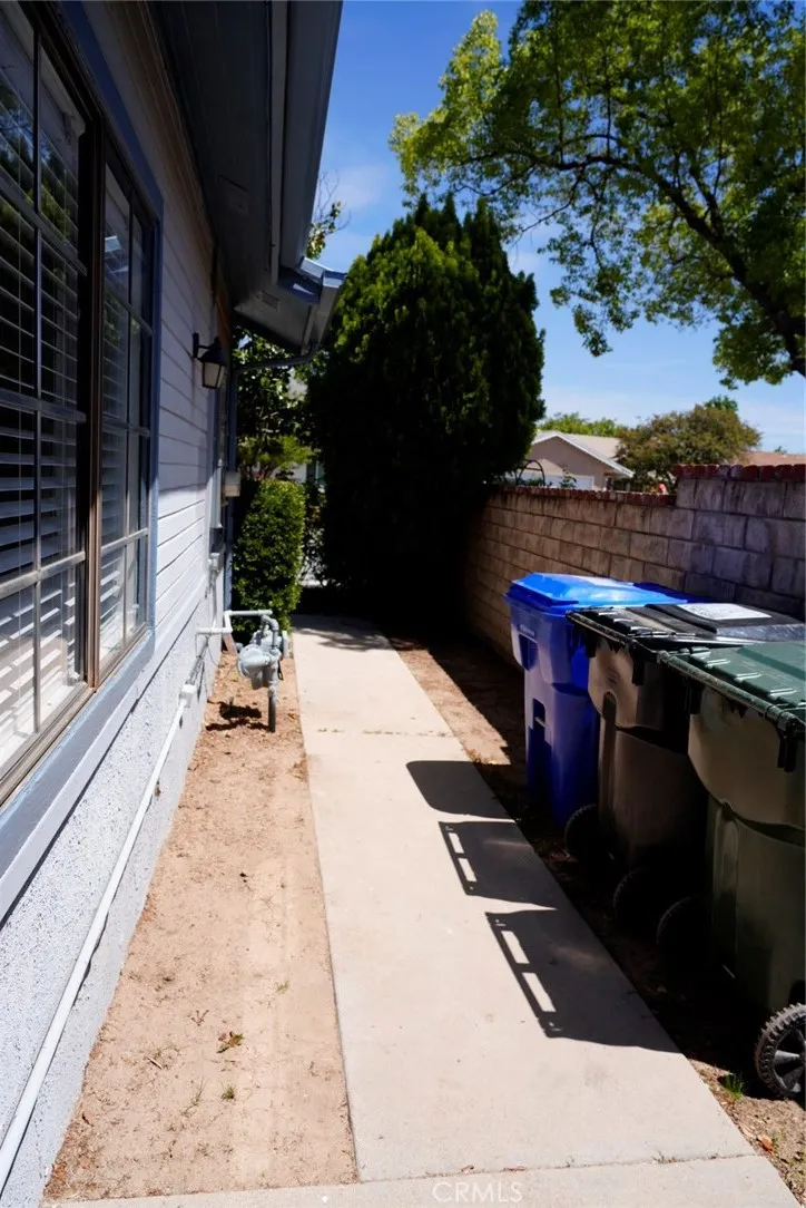 Side yard along garage, located in front of backyard gate
