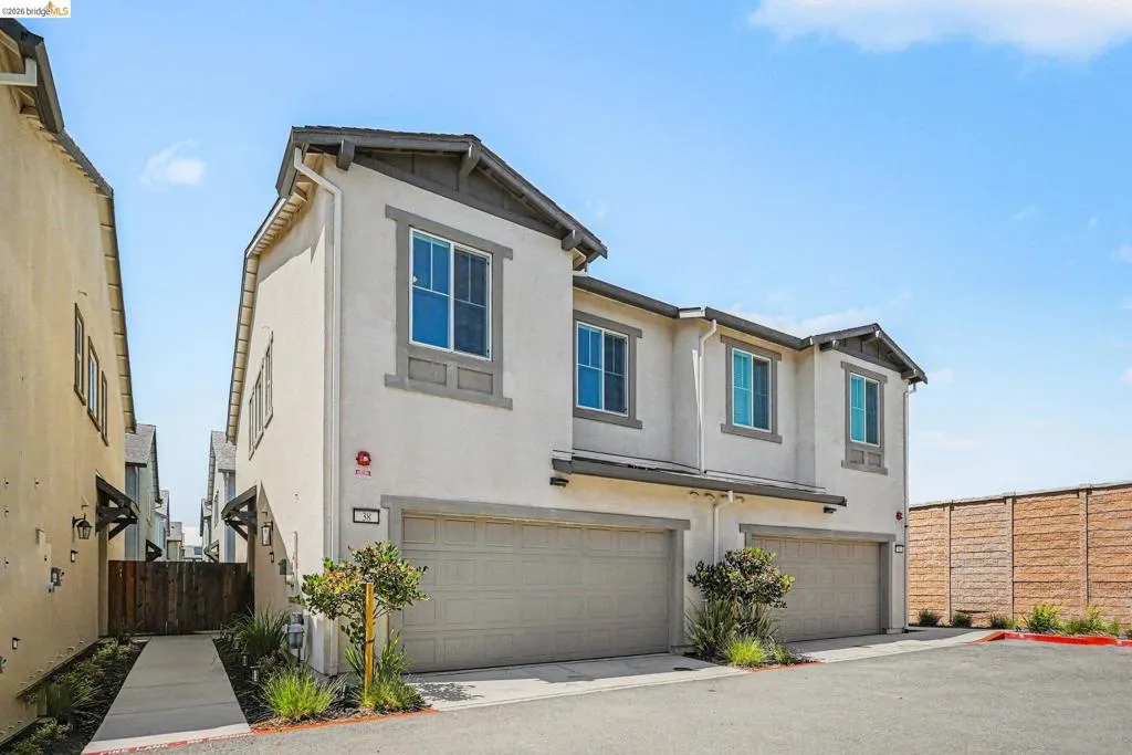 Contemporary two-story stucco exterior with dual attached garage spaces