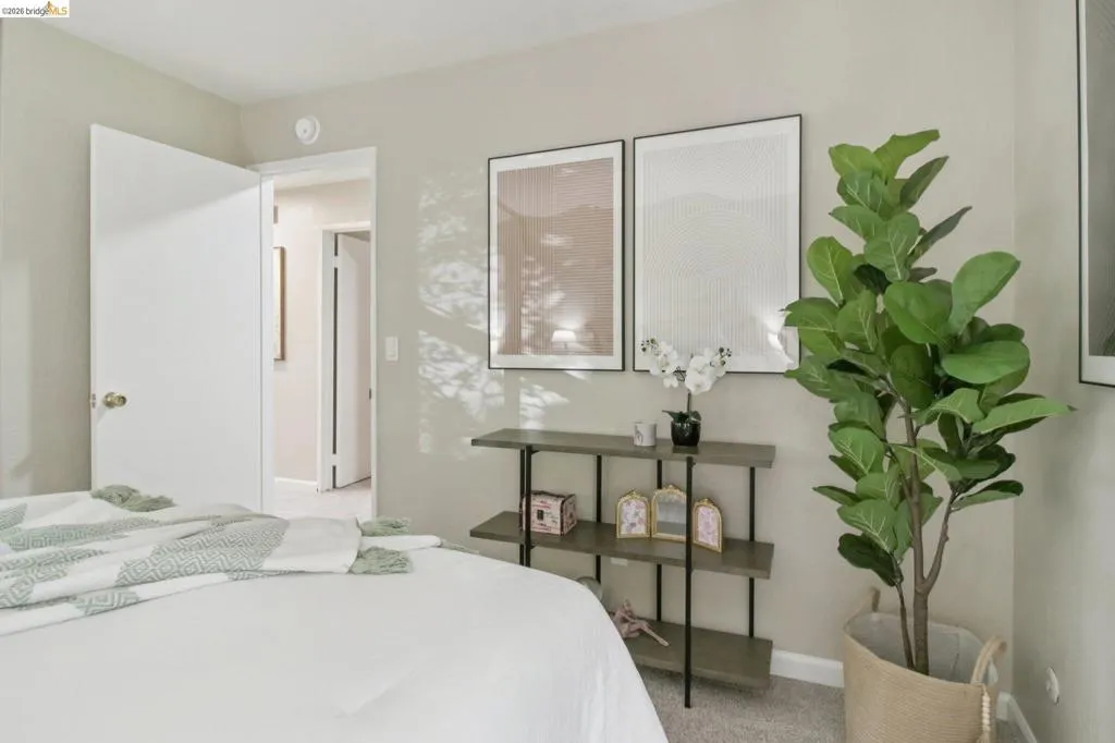 Bedroom with baseboards and light carpet