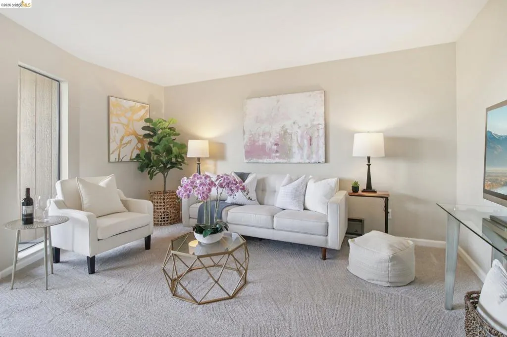 Living area featuring carpet floors and baseboards