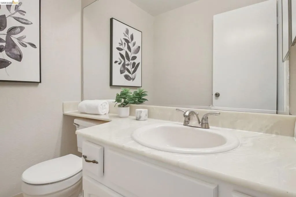 Half bathroom featuring vanity and toilet