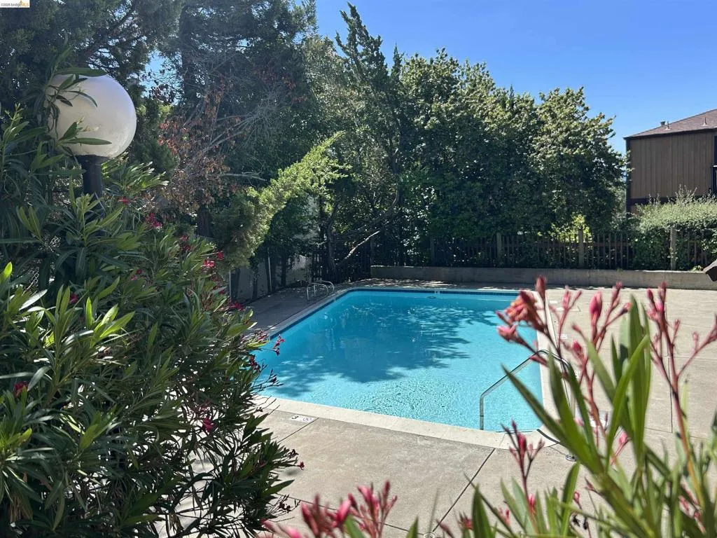View of swimming pool with a fenced backyard and patio surround