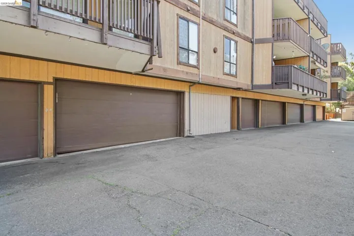 View of building exterior with community garages