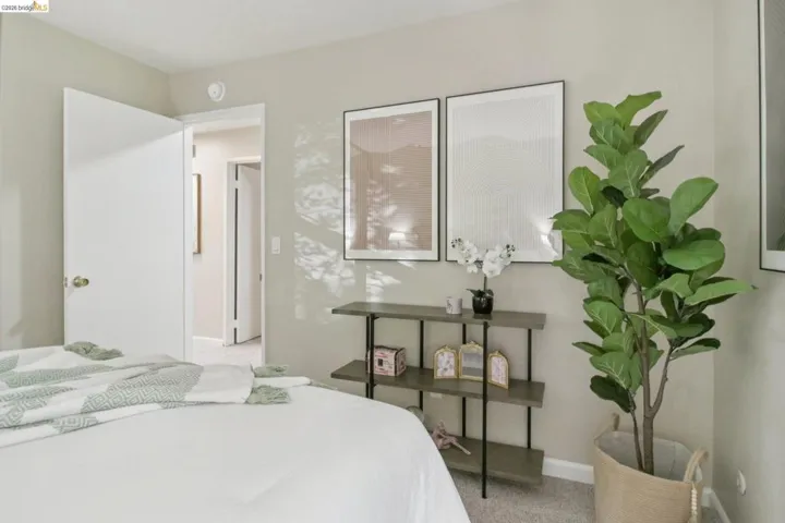 Bedroom with baseboards and light carpet