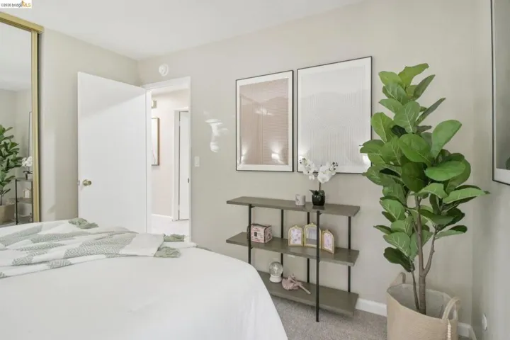 Bedroom featuring baseboards and light colored carpet