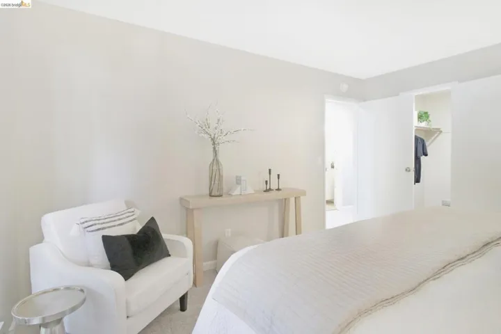Carpeted bedroom featuring a walk in closet