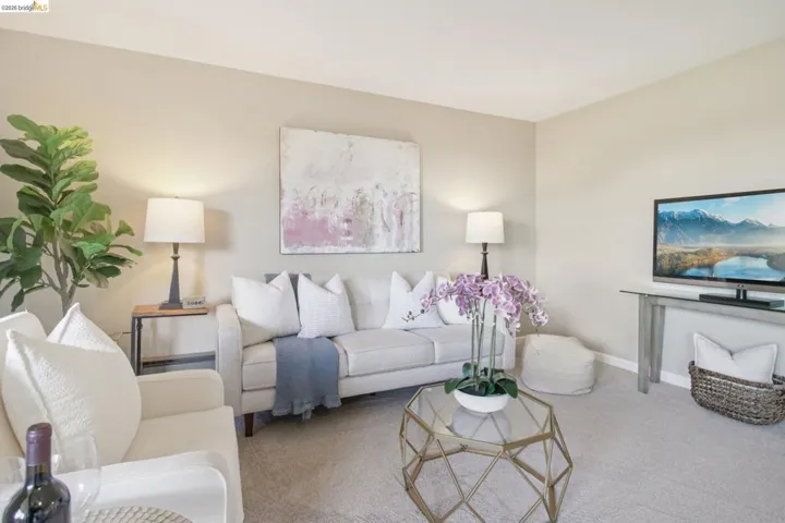 Carpeted living room with baseboards