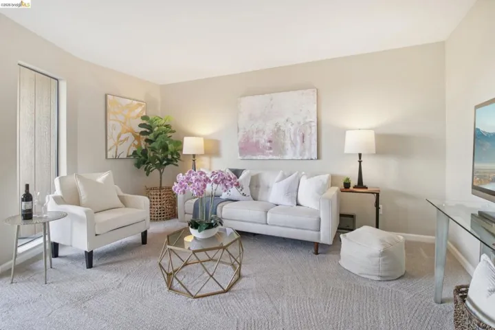 Living area featuring carpet floors and baseboards