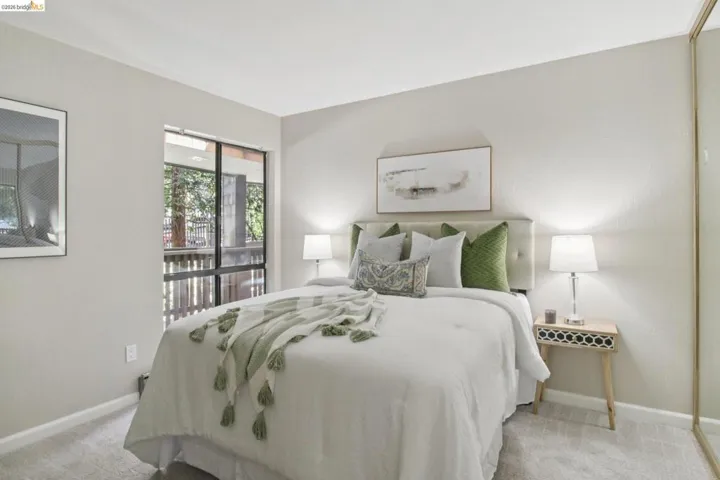 Bedroom with baseboards and light colored carpet