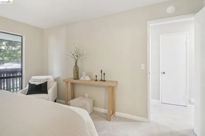 Bedroom with light carpet and baseboards