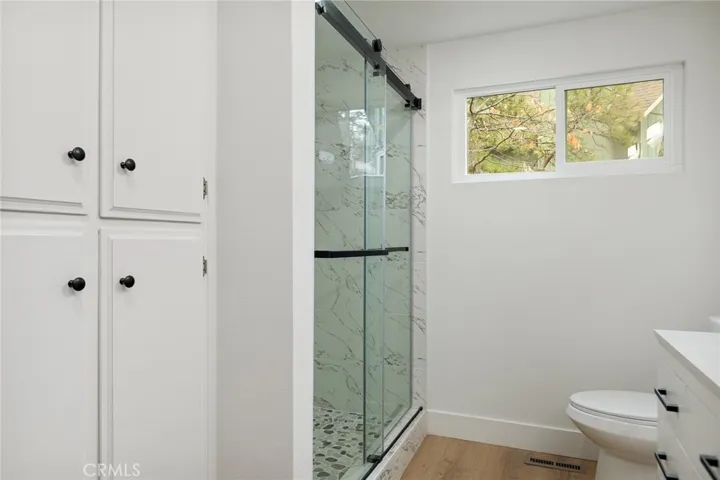 Walk in shower tiled with stoned