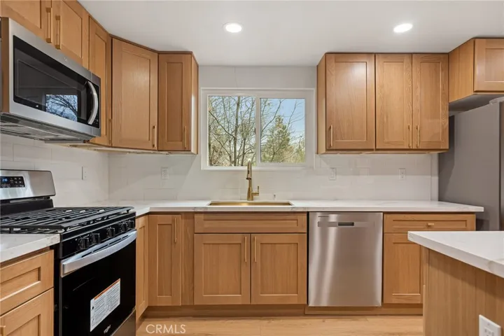 Plenty of counter space w/ a window view of the forest