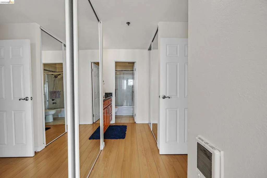 Corridor featuring light wood-type flooring and heating unit