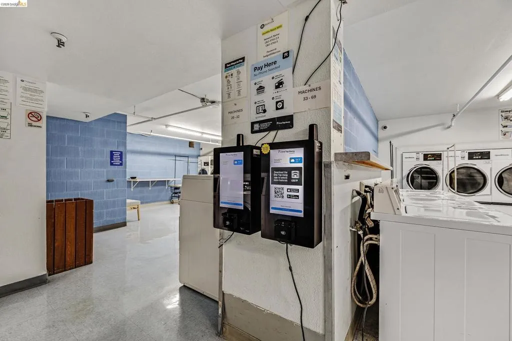 Communal laundry room with washing machine and dryer