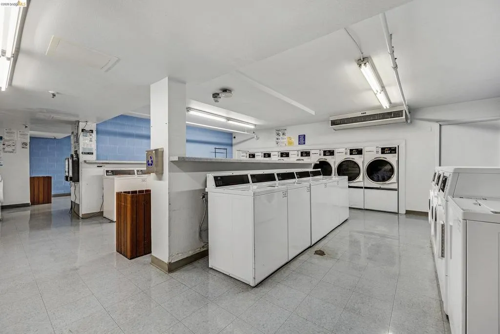 Community laundry featuring washer and clothes dryer