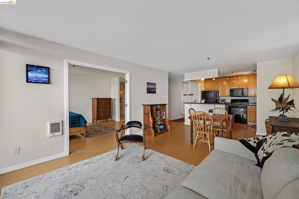 Living room with light wood finished floors and heating unit