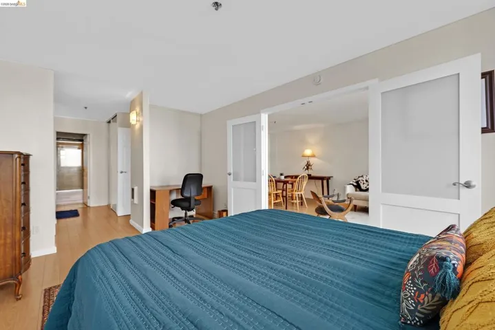 Bedroom featuring an office area and light wood finished floors