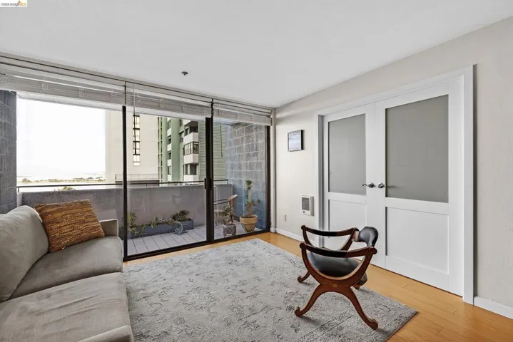 Sitting room featuring light wood-type flooring and french doors