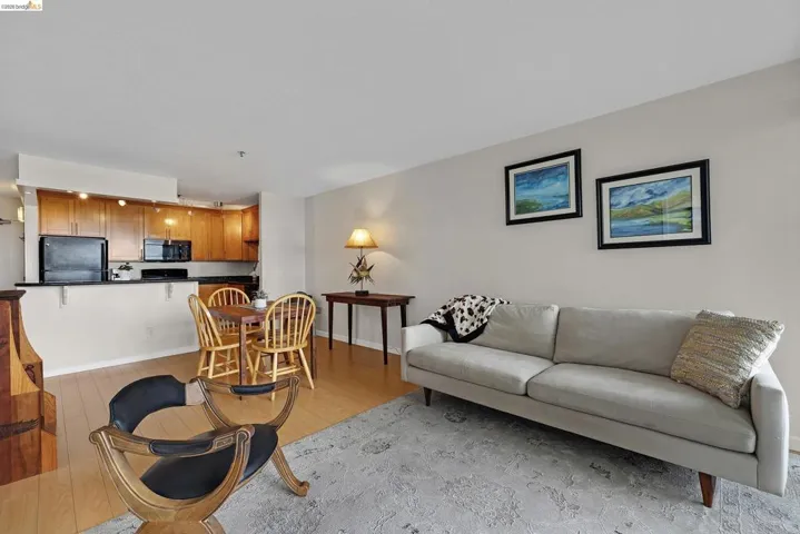 Living room featuring light wood-type flooring and baseboards