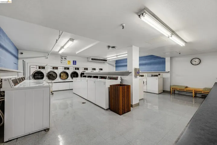 Shared laundry room featuring washer and clothes dryer