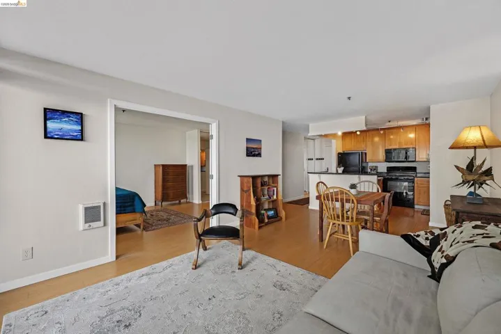 Living room with light wood finished floors and heating unit