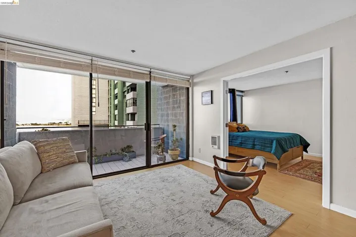 Living room with light wood-type flooring and heating unit