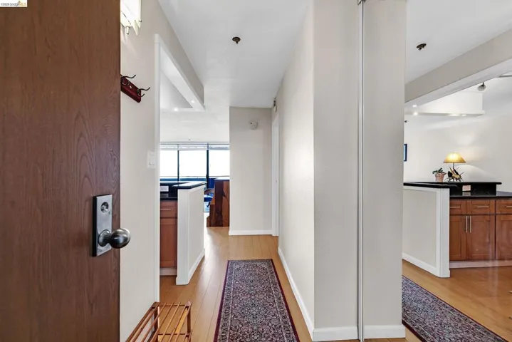 Hall with baseboards and light wood-style flooring