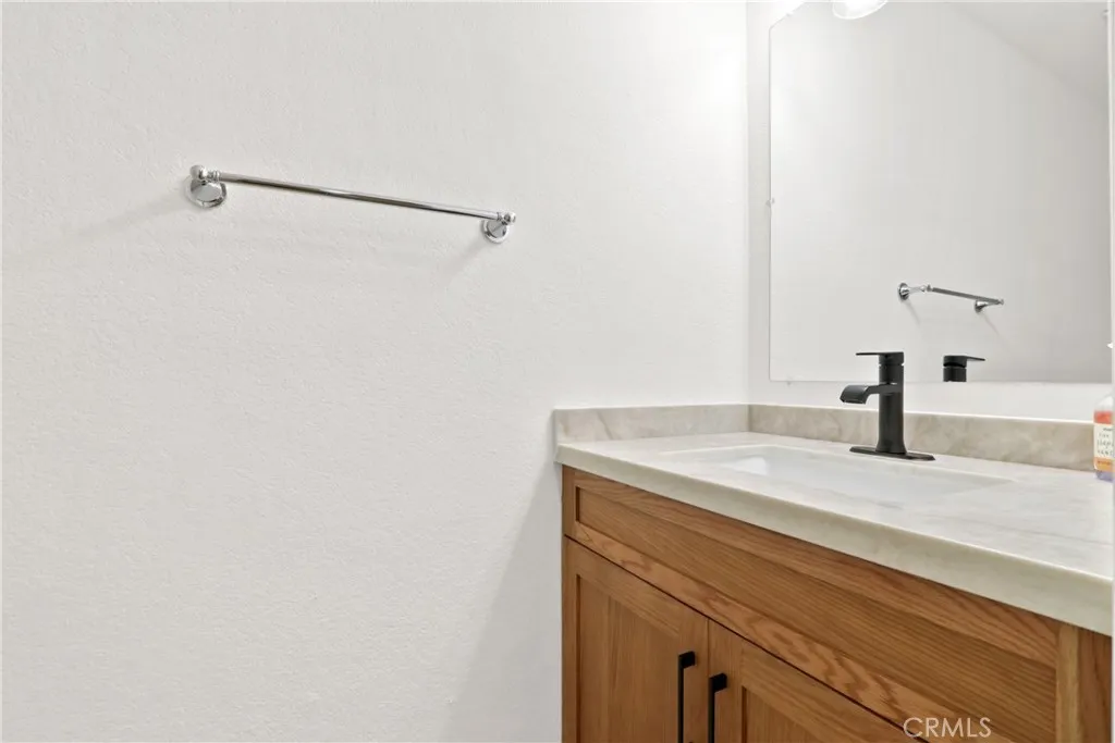 Downstairs powder room with Taj Mahal Quartzite counter