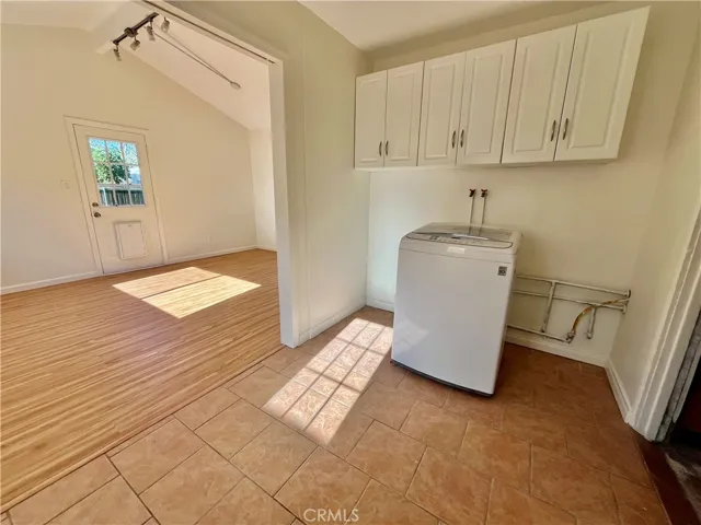 Inside laundry room with washing machine