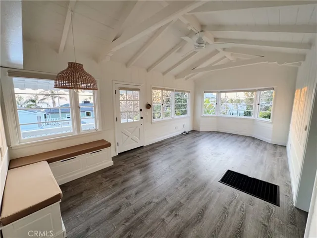 A sun-drenched, expansive open floor plan that seamlessly connects various living areas, coupled with the vintagecharm and architectural interest provided by a beautifully crafted beamed ceiling.
