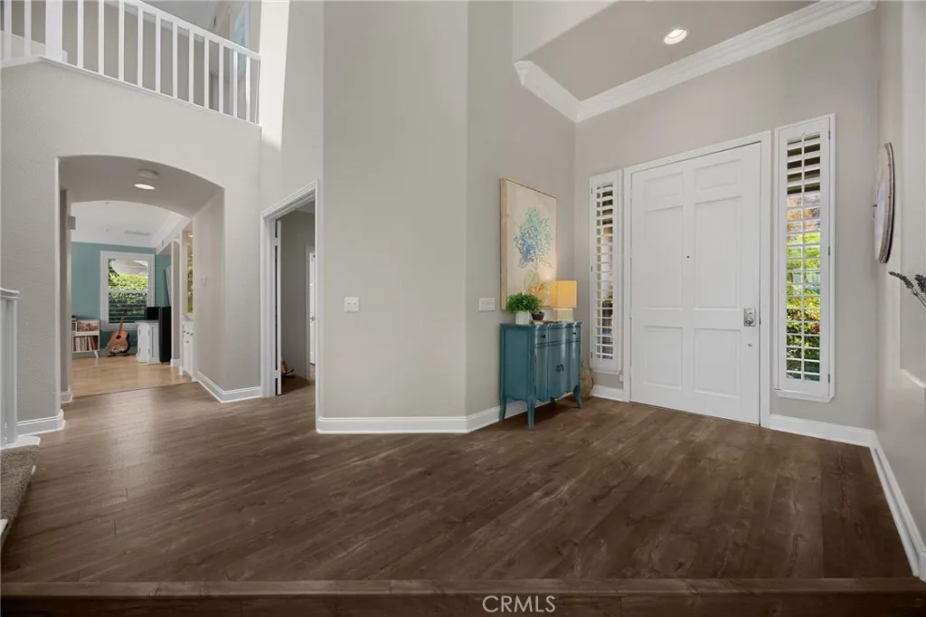 Grand entry with soaring vaulted ceilings, a dramatic staircase, skylight- filled natural light, look out to views and beyond
