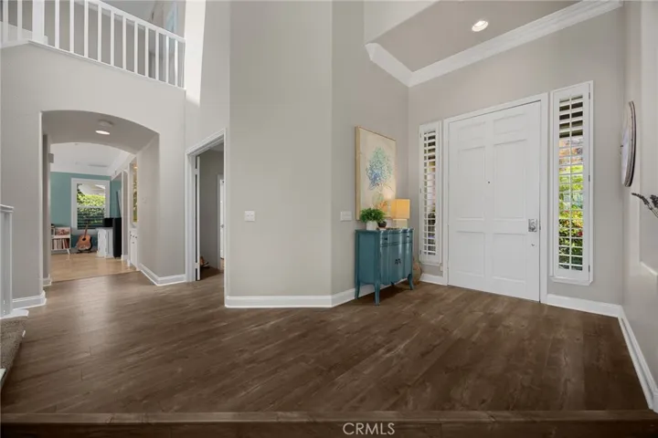 Grand entry with soaring vaulted ceilings, a dramatic staircase, skylight- filled natural light, look out to views and beyond