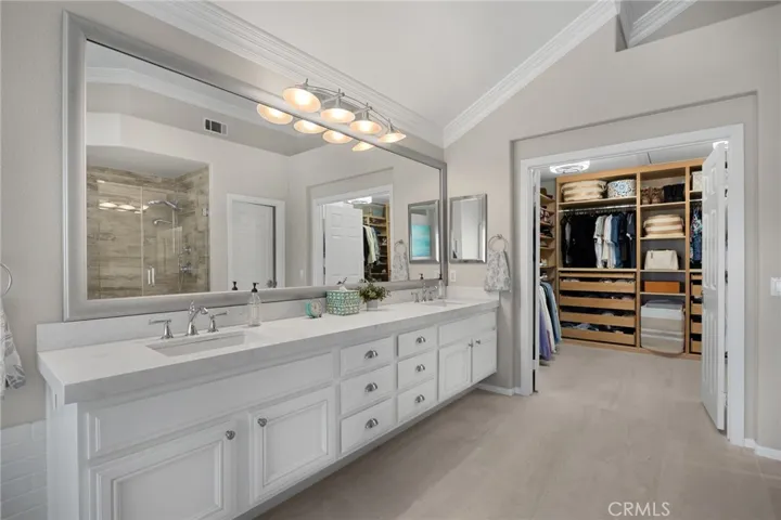 Spa-inspired primary bathroom with dual sinks-quartz, modern hardware, and a calm coastal palette