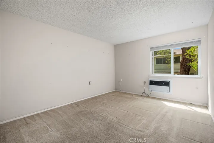 Bedroom has wall hvac for heating and a/c