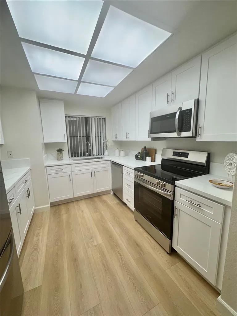 Remodeled Kitchen w/ LED panel lighting that has different Light settings ranging from cool to warm.