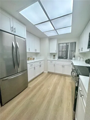 Remodeled Kitchen w/ LED panel lighting that has different Light settings ranging from cool to warm.